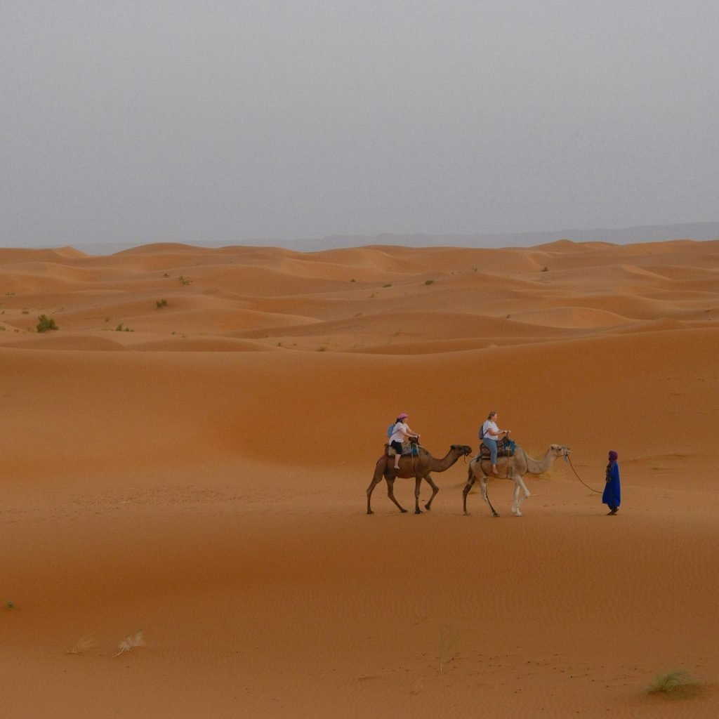 Morocco private desert tours camel trekking at sunset